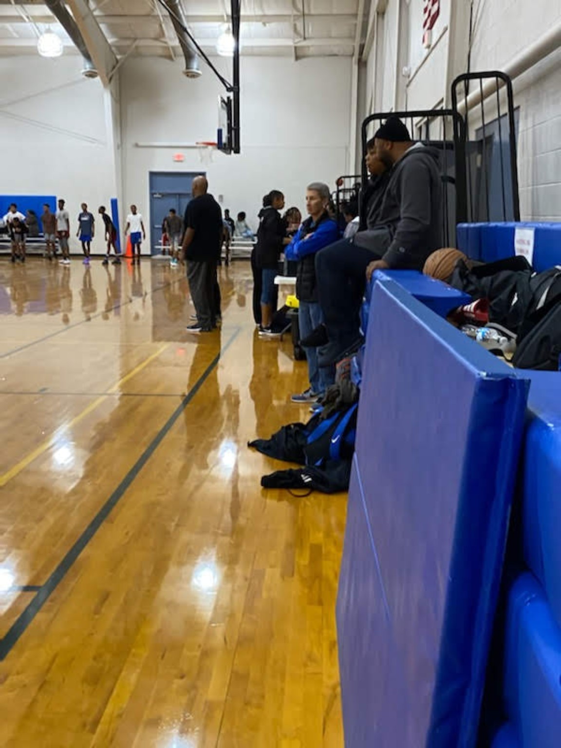 Elite Playmakers 2020 coaches and families along the gym sideline